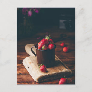 Fresh red strawberries in metal mug on table. postkarte