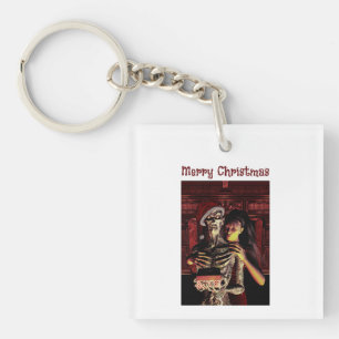 Frohe Weihnachten. Lustiges Skelett mit Frau Schlüsselanhänger