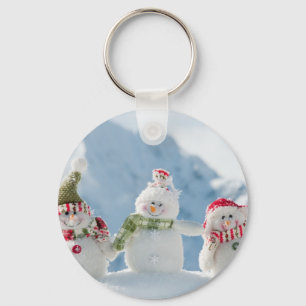 Frohe Weihnachten und glückliche Snowmen im neuen Schlüsselanhänger