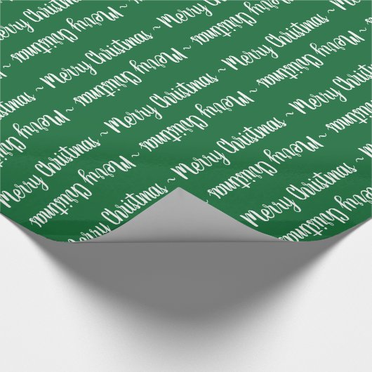 Frohe Weihnachtstypografie in Weiß auf grünem Gesc Geschenkpapier (Ecke)