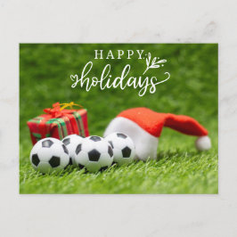 Froher Fußballurlaub mit Weihnachtsmannmütze Weihn Feiertagspostkarte