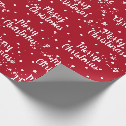 Fröhlicher Weihnachtstext in Schneeflocken auf rot Geschenkpapier (Ecke)