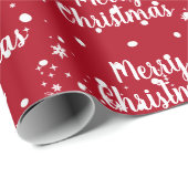 Fröhlicher Weihnachtstext in Schneeflocken auf rot Geschenkpapier (Rolleneckpunkt)