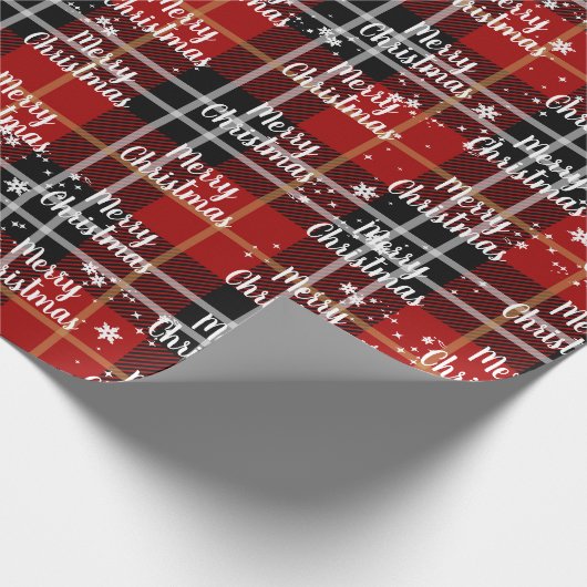 Fröhlicher Weihnachtstext in Schneeflocken auf Tar Geschenkpapier (Ecke)