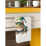 Froscher Weihnachtsfrosch, Brauch Geschirrtuch<br><div class="desc">Bringen Sie Ihrer Küche einen Hauch von festlichem Charme mit unserem bezaubernden "Frolischen Weihnachtsfrosch" individualisierbaren Küchentuch! Dieses reizende Design mit einem fröhlichen, wasserfarbenen grünen Baumfrosch, der in einer festlich grünen Weihnachtsmannmütze verziert ist und bereit ist, in Ihren Urlaub zu kochen und zu backen. Es ist der perfekte Weg, Ihre Küchendekoration...</div>
