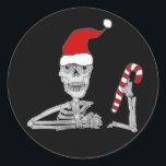 Funny Skeleton in Santa hat Christmas Runder Aufkleber<br><div class="desc">Cool cute fun skeleton wearing Santa hat and holding candy cane Christmas cartoon is popular with skeleton lovers and Goths and satire lovers for Christmas holidays.</div>
