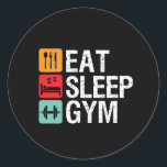 Funny Workout Fitness Übung Essen Schlaf Gym Runder Aufkleber<br><div class="desc">Iss Schlafanzug. Das Design ist fein, schnörkellos und leise für alle, die im Fitnessraum trainieren, Laufband laufen, trainieren und trainieren. Diese Fitness Fitnessstudio Motivation Ware ist großartig zu tragen, wenn es Squats, Heft, Gebäude Muskel am Gymnasium. Ideal für Bodybuilder, Gymnastiktrainer und Fitness-Instruktor. Große Weihnachtsgeschenke und Geburtstagsgeschenk für jemanden, der Spaß,...</div>