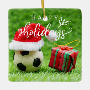 Fußball-Happy Holidays mit Ball auf grünem Gras Keramikornament