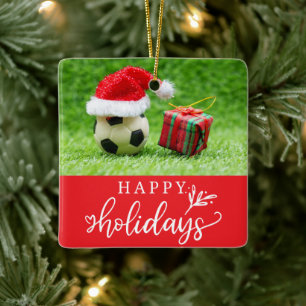 Fußball-Happy Holidays mit Ball auf grünem Gras Keramikornament