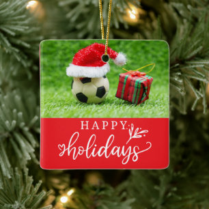 Fußball-Happy Holidays mit Ball auf grünem Gras Keramikornament