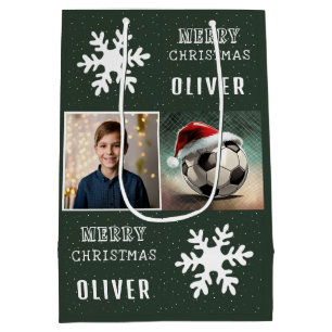 Fußball mit Weihnachtsmannmütze Schneeflocken Foto Mittlere Geschenktüte