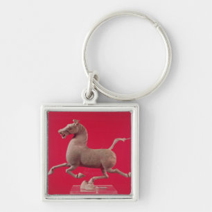 Galoppierendes Pferd mit einem Huf, der auf a Schlüsselanhänger