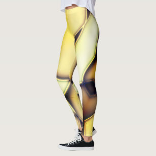 Gekrümmte glatte, goldene Linien über verbranntes Leggings