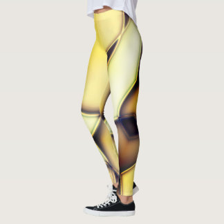 Gekrümmte glatte, goldene Linien über verbranntes Leggings
