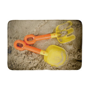 Gelb und orange Sandspielzeug am Strand drucken Badematte