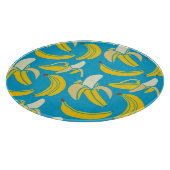 Gelbe Bananen, blaues Hintergrundmuster Schneidebrett (Ecke)