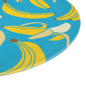 Gelbe Bananen, blaues Hintergrundmuster Schneidebrett (Ecke)