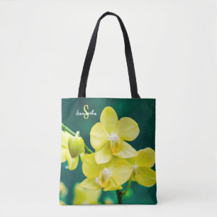 Gelbe Orchidee auf grüner Tragetasche Tasche