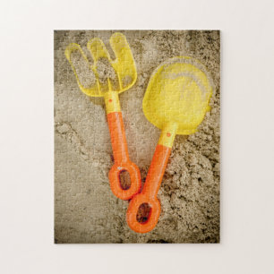 Gelbe und orangefarbene Sandspielzeuge Puzzle
