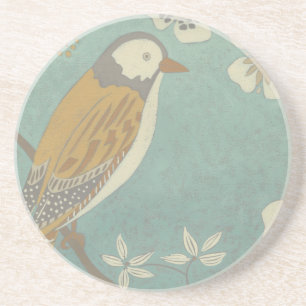 Gelber, grauer und beige Vogel gehockt auf einer Getränkeuntersetzer