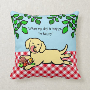 Gelber Labradorwelpe und -hamburger Kissen