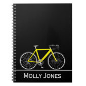Gelbes Rad mit Namen auf schwarz Notizblock (Vorderseite)