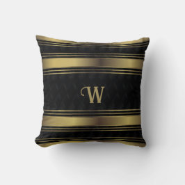 Geometrisches Monogramm aus schwarzen und goldenen Kissen