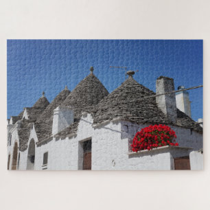 Geranium Blume und Trulli Häuser in Alberobello Puzzle
