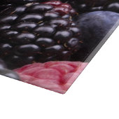 Geschmackvolle Sommer-Früchte auf einer hölzernen Schneidebrett (Ecke)