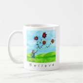 "Glaube an das Unmögliche" Mädchen mit Blume Kites Kaffeetasse (Links)