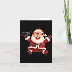 Glücklicher Weihnachtsmann mit Drohne für viele un Karte