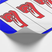 Glückliches Sevens im roten weißen und blauen Geschenkpapier (Ecke)