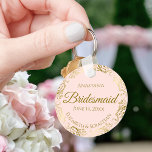 Gold Frills on Pink Bridesmaid Wedding Gift Schlüsselanhänger<br><div class="desc">These keychains are designed to give as favors to bridesmaids in your wedding party. They feature a simple yet elegant design with a pale blush pink colored background, gold script lettering, and a lacy golden faux foil floral border. The text says "Bridesmaid" with space for her name, the names of...</div>