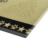 Gold glänzende Weihnachtssterne, Pfoten auf Gold u Schneidebrett (Ecke)