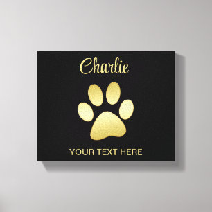 Gold Shiny Dog Paw auf schwarzem Hintergrund Leinwanddruck