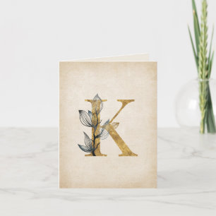 Gold- und schwarzes K-Monogramm mit Blättern