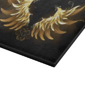 Golden Angel Wings auf schwarzem Hintergrund Schneidebrett (Ecke)
