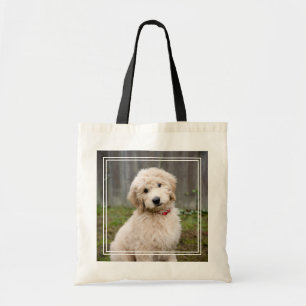 Goldendoodle-Welpen im Gras Tragetasche