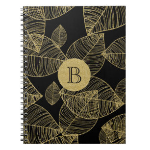 Goldene Blätter auf schwarzem eleganten Notizbuch Notizblock
