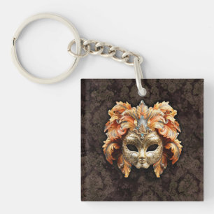 Goldene Löwenmaske mit orangen Federn Schlüsselanhänger