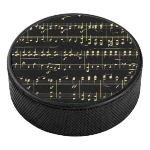 Goldene Musik auf schwarz Eishockey Puck