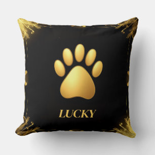 Goldene Paw-Print gegen schwarzen Hintergrund Kissen