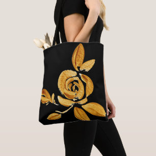 Goldene Rose auf schwarzer Tasche