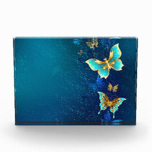 Goldene Schmetterlinge auf blauem Hintergrund Fotoblock