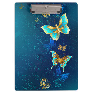 Goldene Schmetterlinge auf blauem Hintergrund Klemmbrett