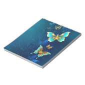 Goldene Schmetterlinge auf blauem Hintergrund Notizblock (Rotiert)