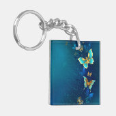 Goldene Schmetterlinge auf blauem Hintergrund Schlüsselanhänger (Vorderseite links)