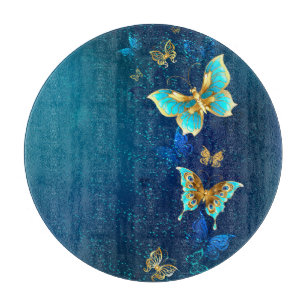 Goldene Schmetterlinge auf blauem Hintergrund Schneidebrett