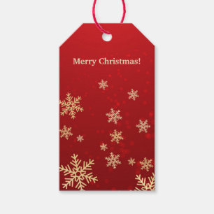 Goldene Schneeflocken auf roten Geschenkanhänger