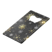 Goldene Schneeflocken auf schwarzem Hintergrund Geldbeutel Flaschenöffner (Vorderseite Schrägansicht)